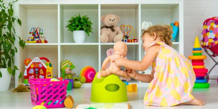 Children sit on the potty in the room. Selective focus.