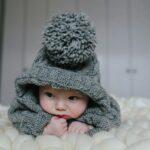 Small baby in knitted clothes