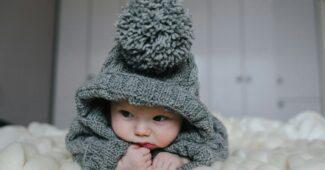 Small baby in knitted clothes