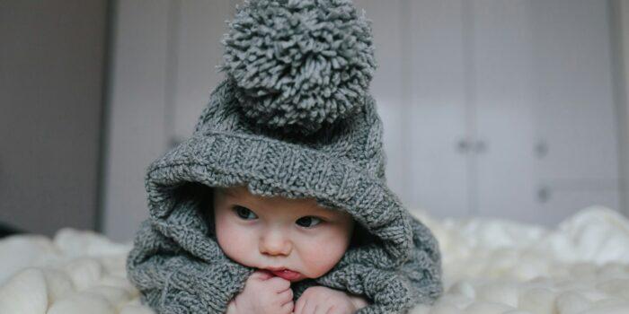 Small baby in knitted clothes